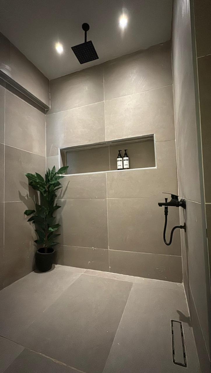 mvic525-u12 Rain shower with a tiled niche in a grey bathroom - apartment in Mountain View iCity, New Cairo