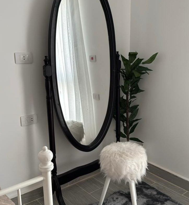 Oval standing mirror with a fluffy stool - apartment in Mountain View iCity, New Cairo