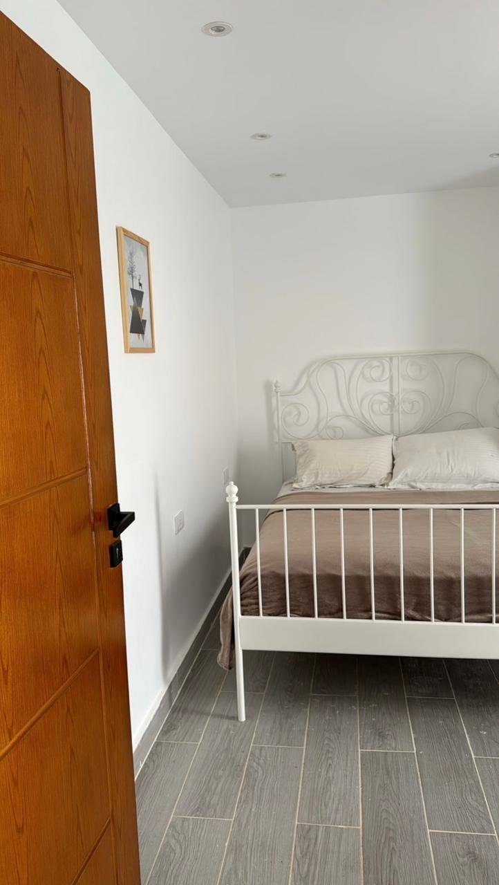 mvic525-u4 White metal bed beside an orange wooden door - apartment in Mountain View iCity, New Cairo
