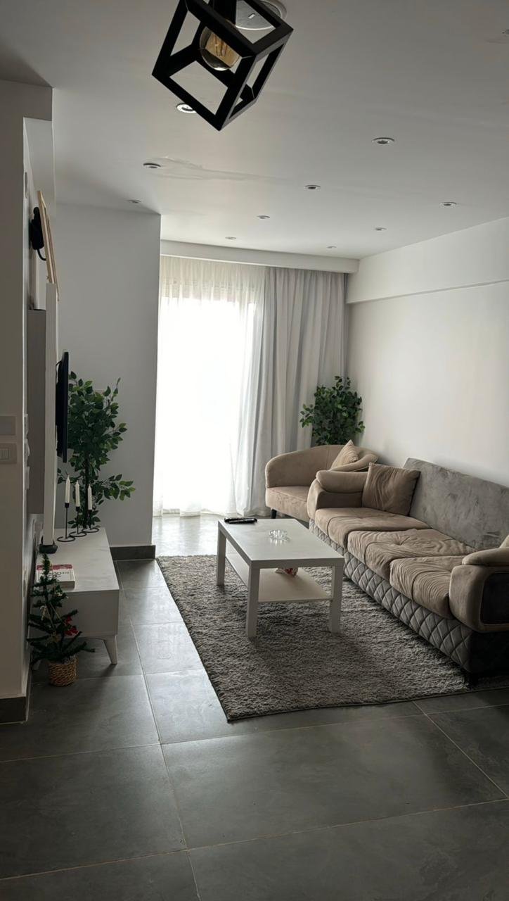 mvic525-u7 Studio living room with a grey rug and black pendant lamp - apartment in Mountain View iCity, New Cairo