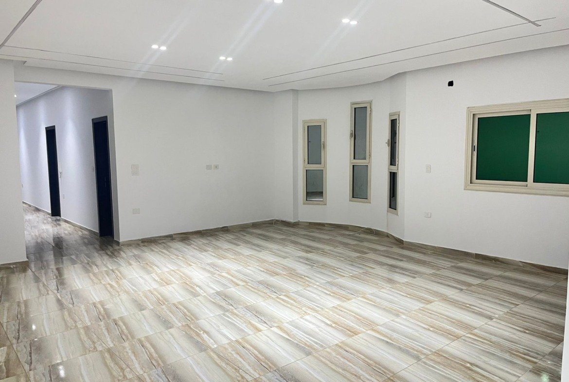 View down the reception toward the hallway and bedrooms - unit in Marassi