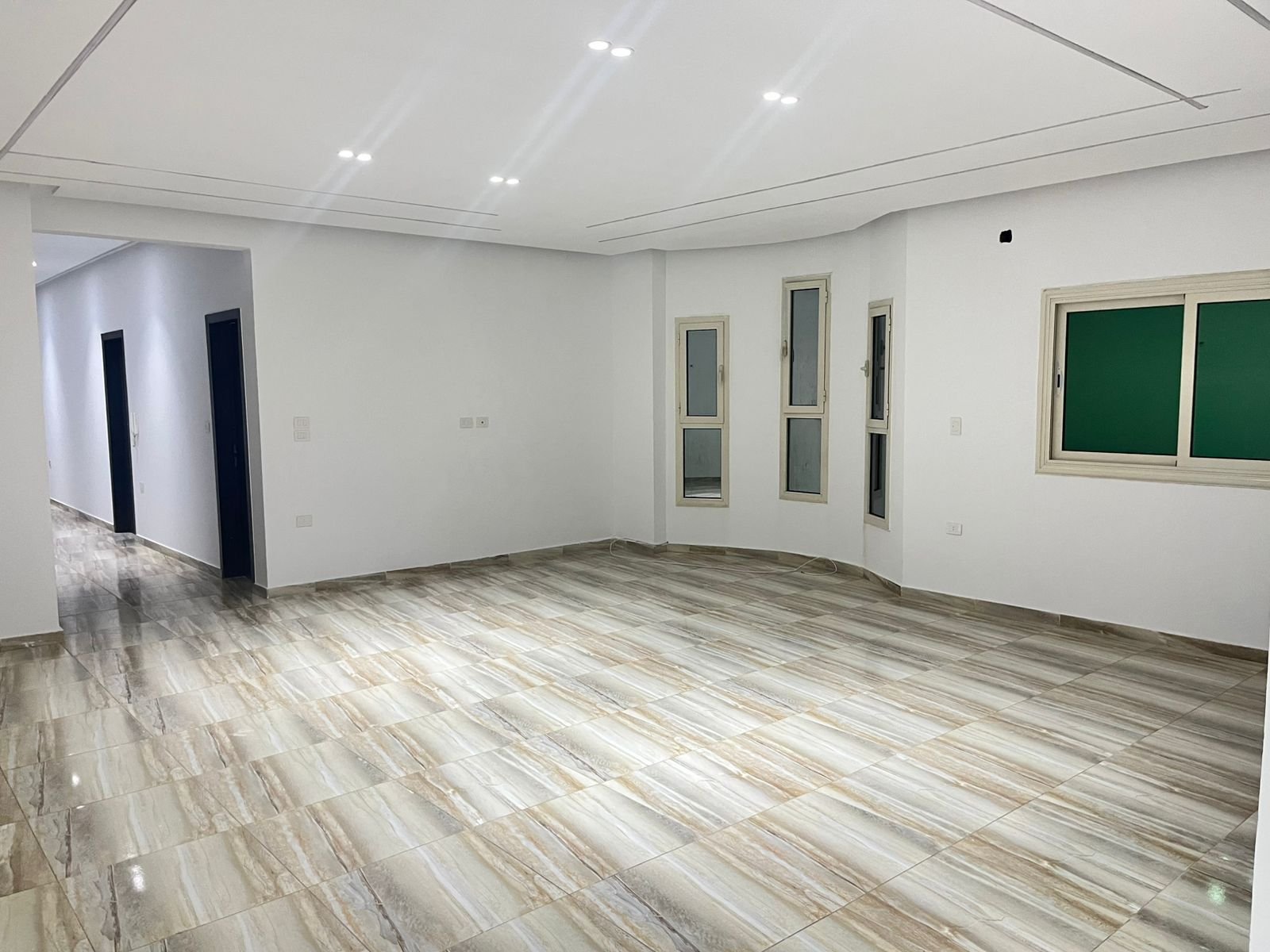 View down the reception toward the hallway and bedrooms - unit in Marassi