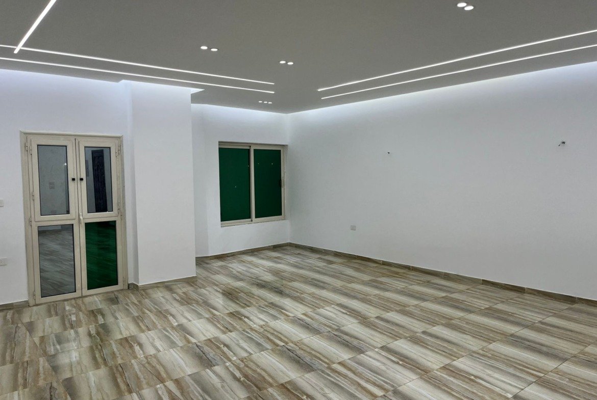Wide room with plank-look floor tiles and glass doors - unit in Marassi