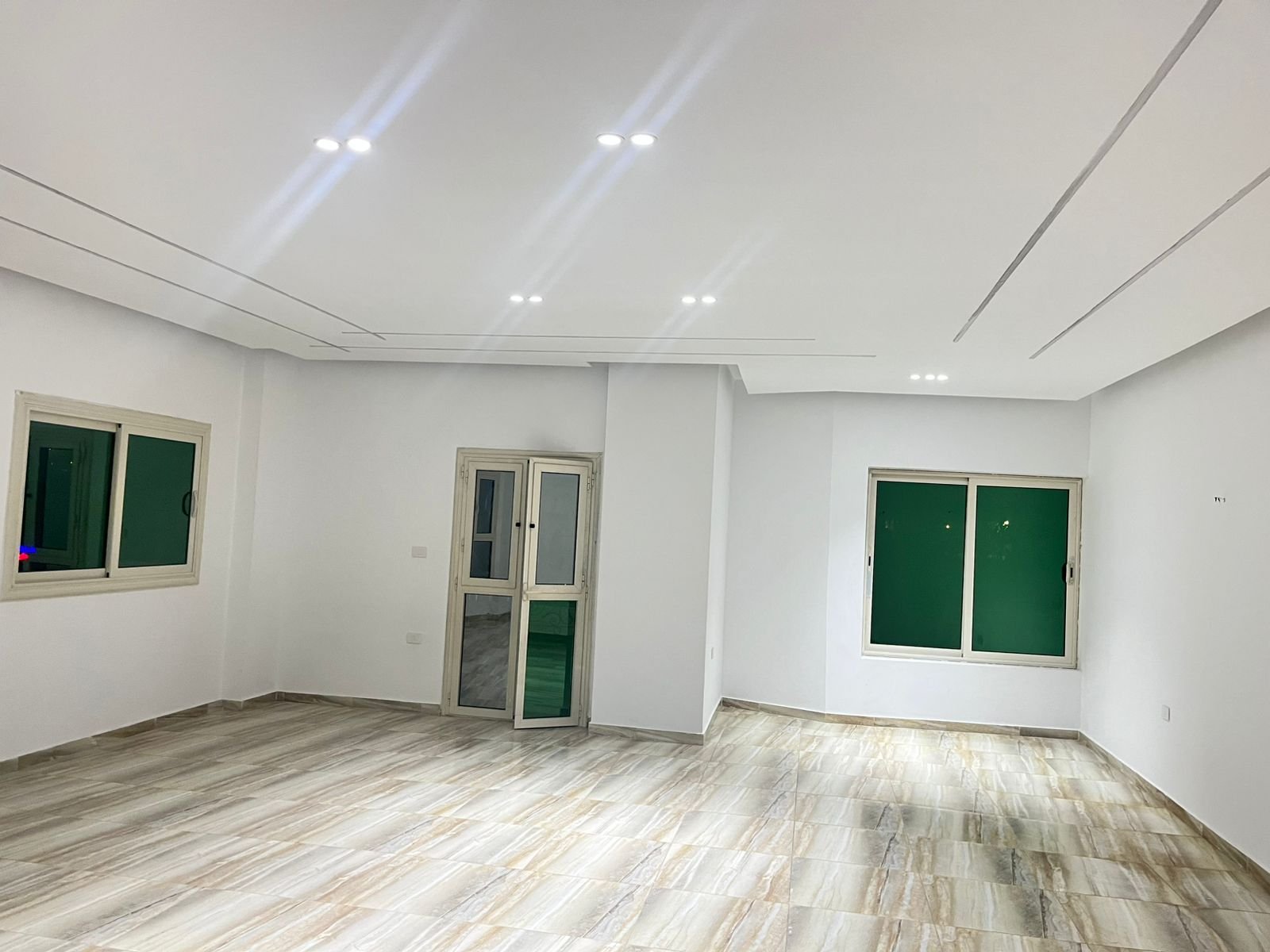 Reception facing two green-shuttered windows - unit in Marassi