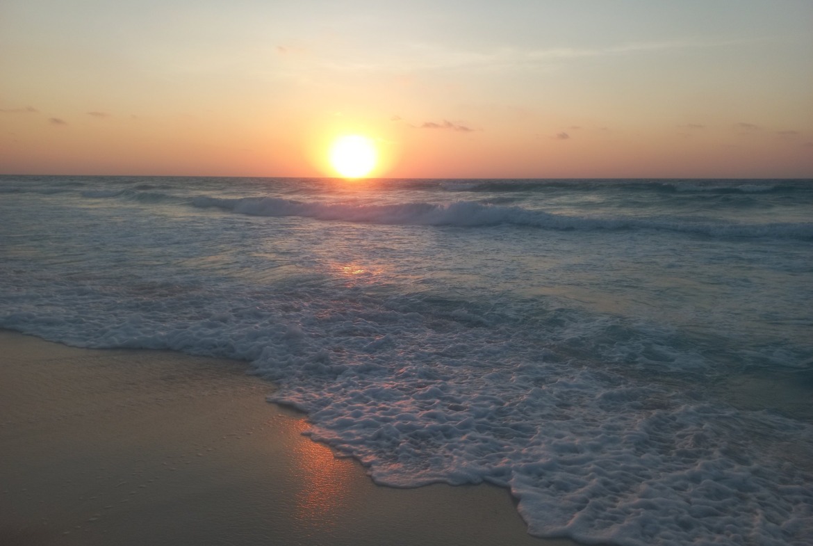 Sunset over the sea with foamy waves - chalet in North Coast