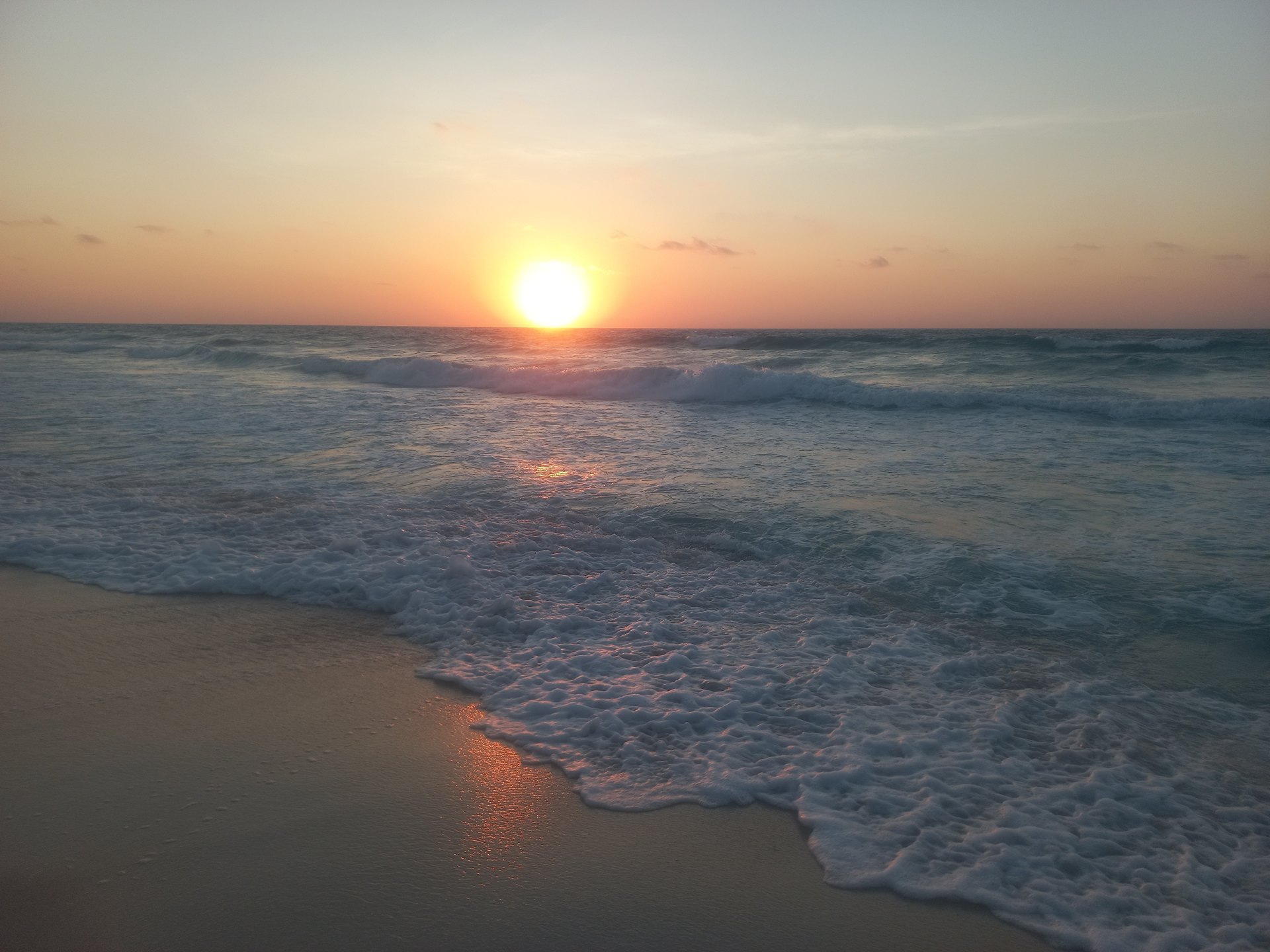 Sunset over the sea with foamy waves - chalet in North Coast