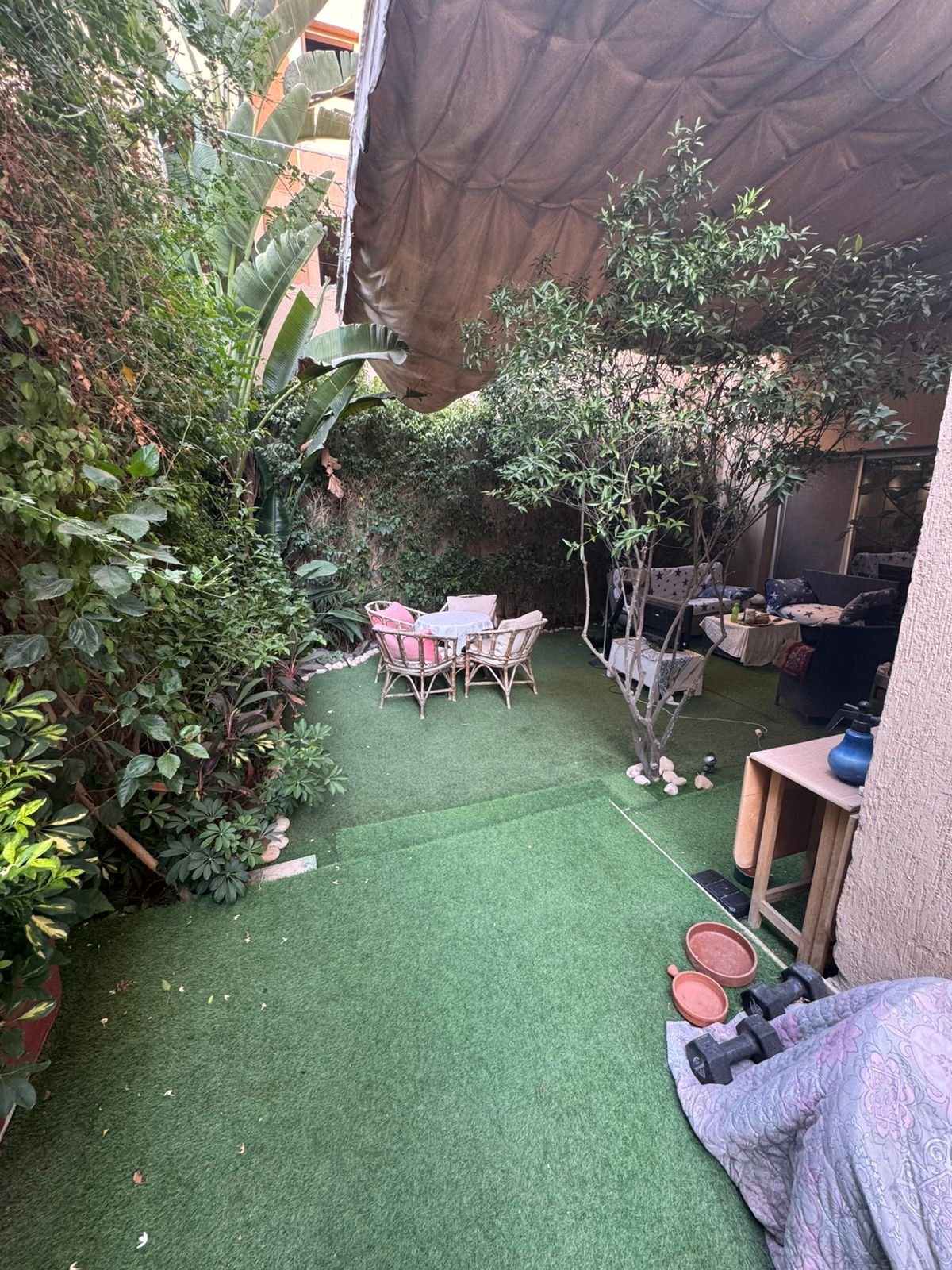 Small garden terrace with plants and a bistro set - duplex in One Piece, New Cairo