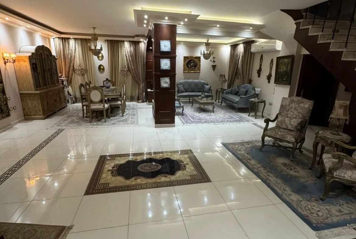Reception with a black-bordered marble floor and a lit ceiling - duplex in One Piece, New Cairo