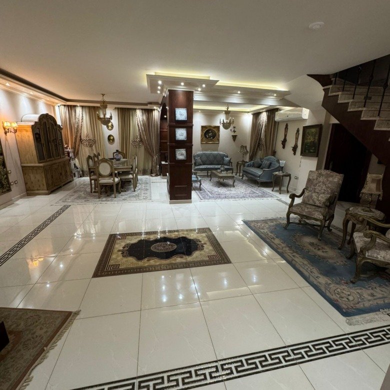 Reception with a black-bordered marble floor and a lit ceiling - duplex in One Piece, New Cairo