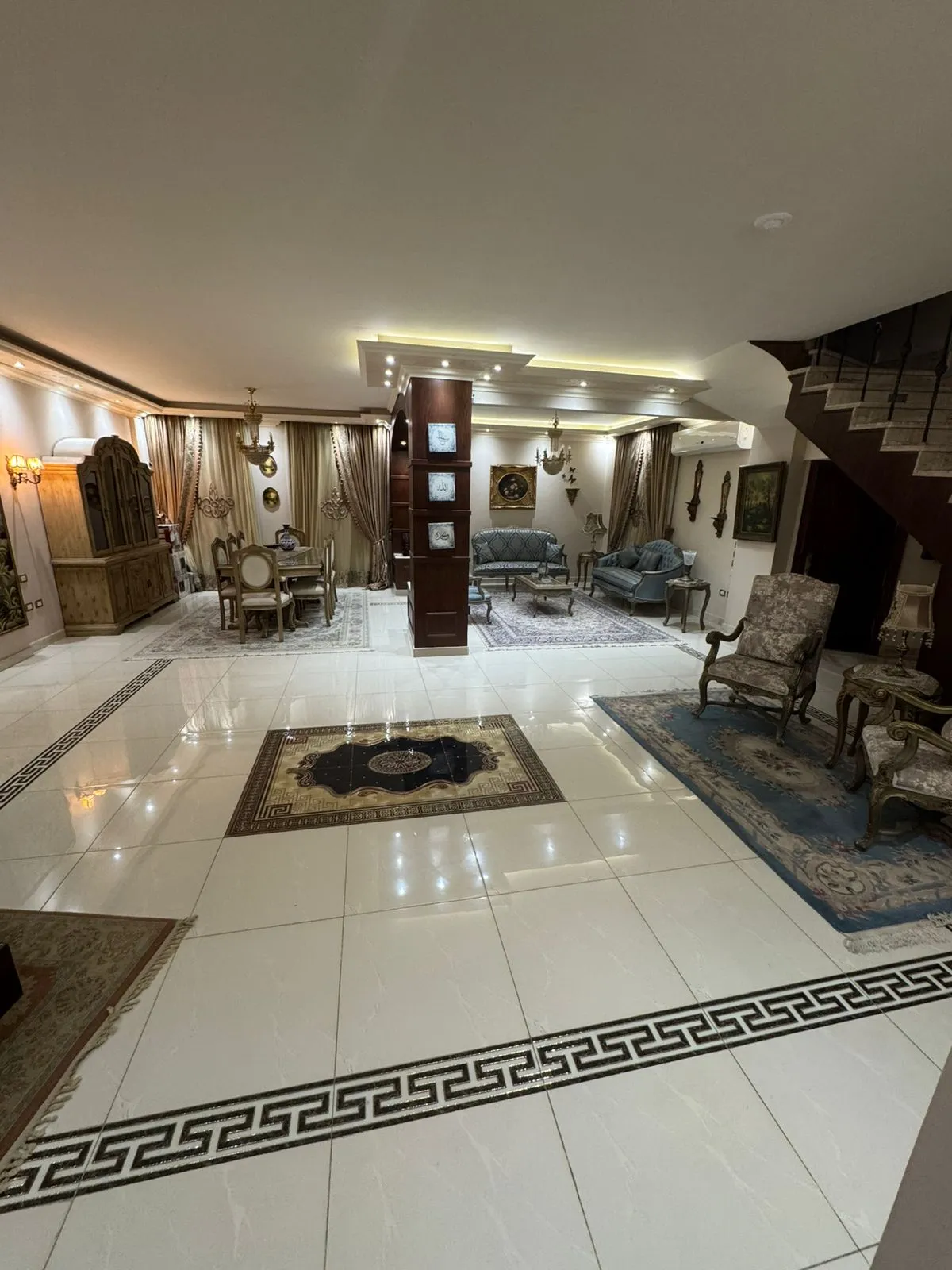 Reception with a black-bordered marble floor and a lit ceiling - duplex in One Piece, New Cairo