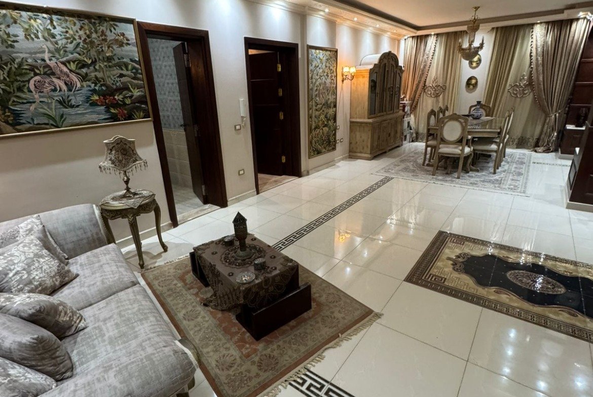 Living area with a beige sofa and decorative lighting - duplex in One Piece, New Cairo