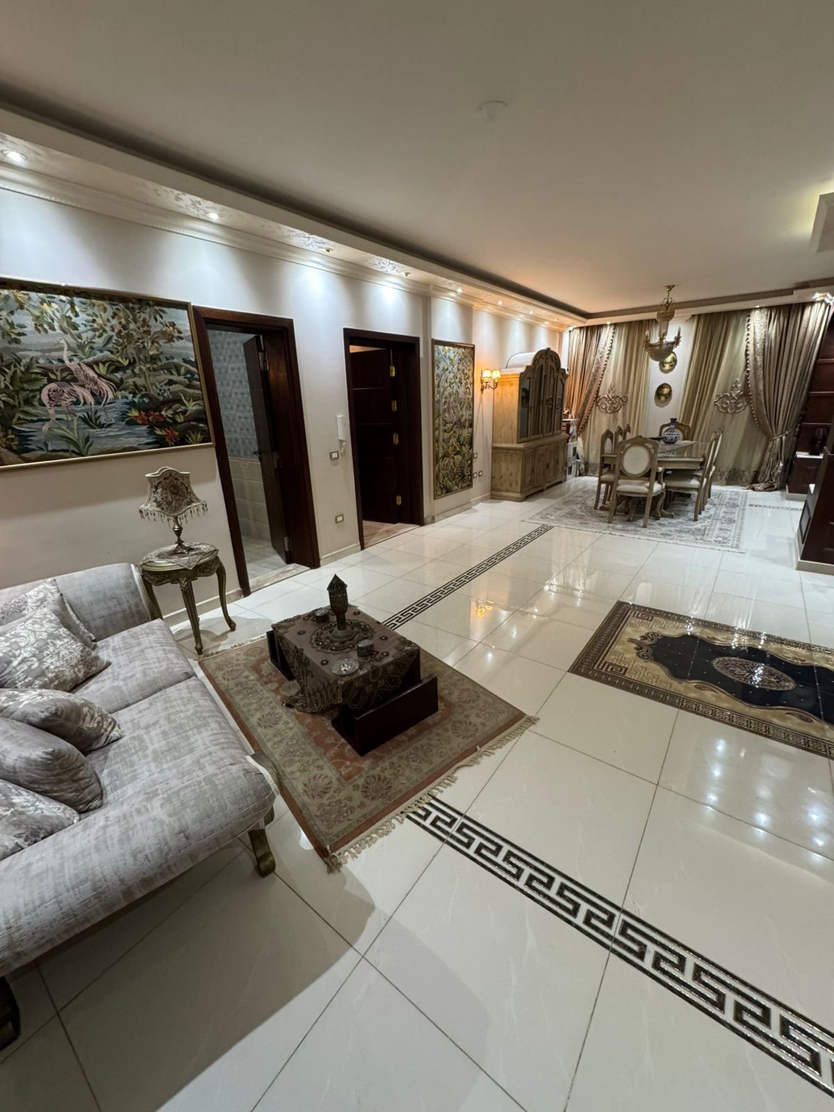 Living area with a beige sofa and decorative lighting - duplex in One Piece, New Cairo