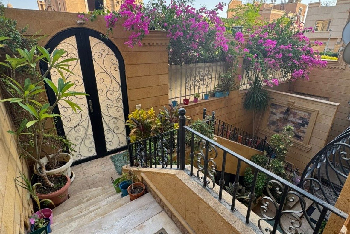Courtyard stairs with bougainvillea flowers - duplex in One Piece, New Cairo