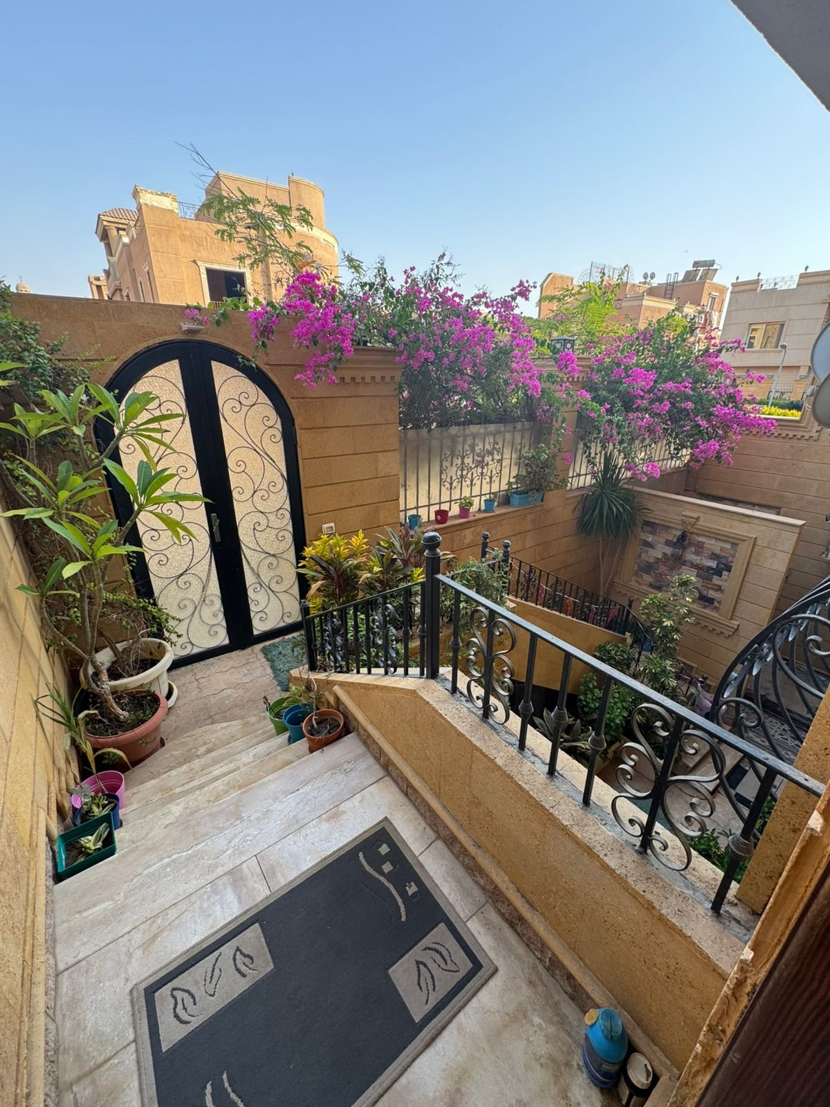Courtyard stairs with bougainvillea flowers - duplex in One Piece, New Cairo