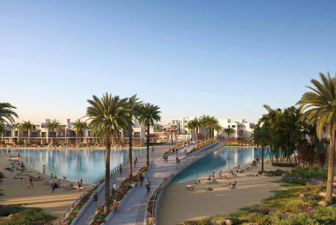 Lagoon with a footbridge and palm trees at sunset - chalet in Ora, North Coast