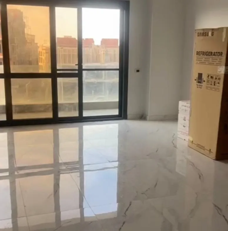 New room with glossy marble floors and a balcony window - apartment in El Patio Oro, New Cairo