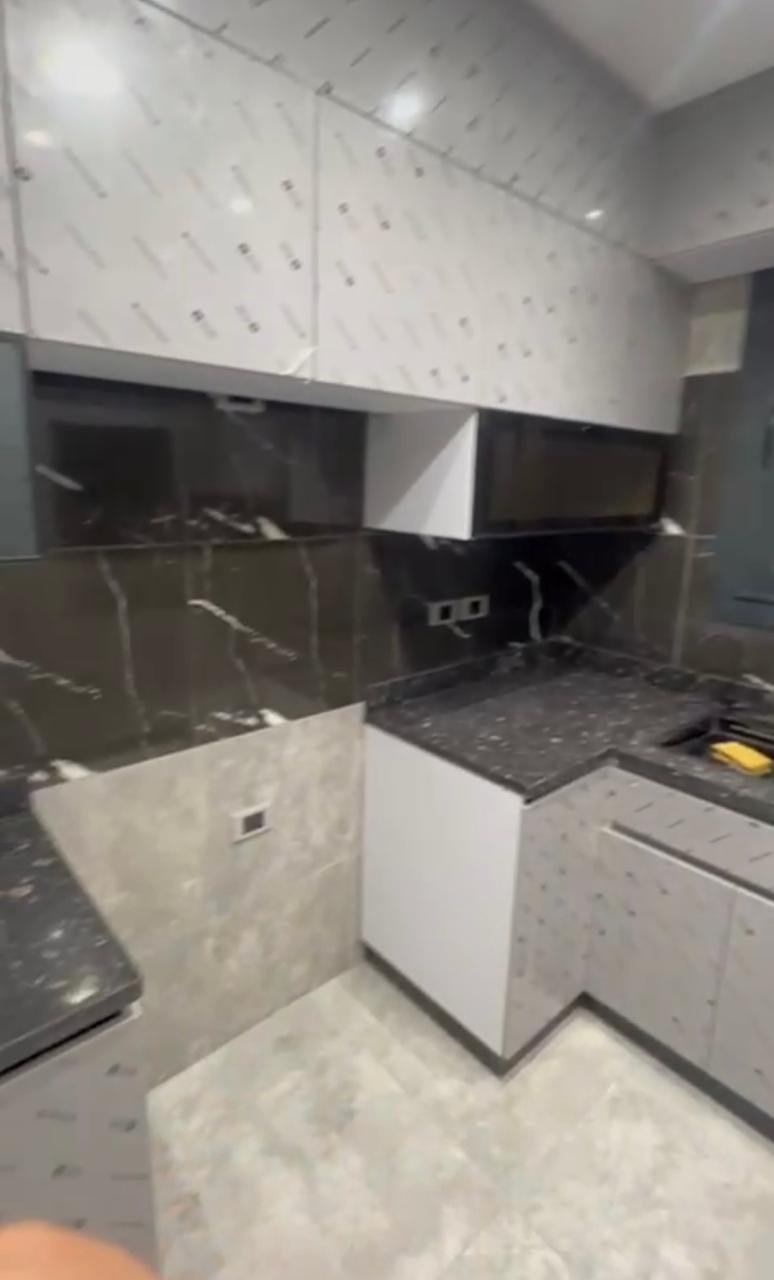 New kitchen with dark marble counters and grey wall tiles - apartment in El Patio Oro, New Cairo