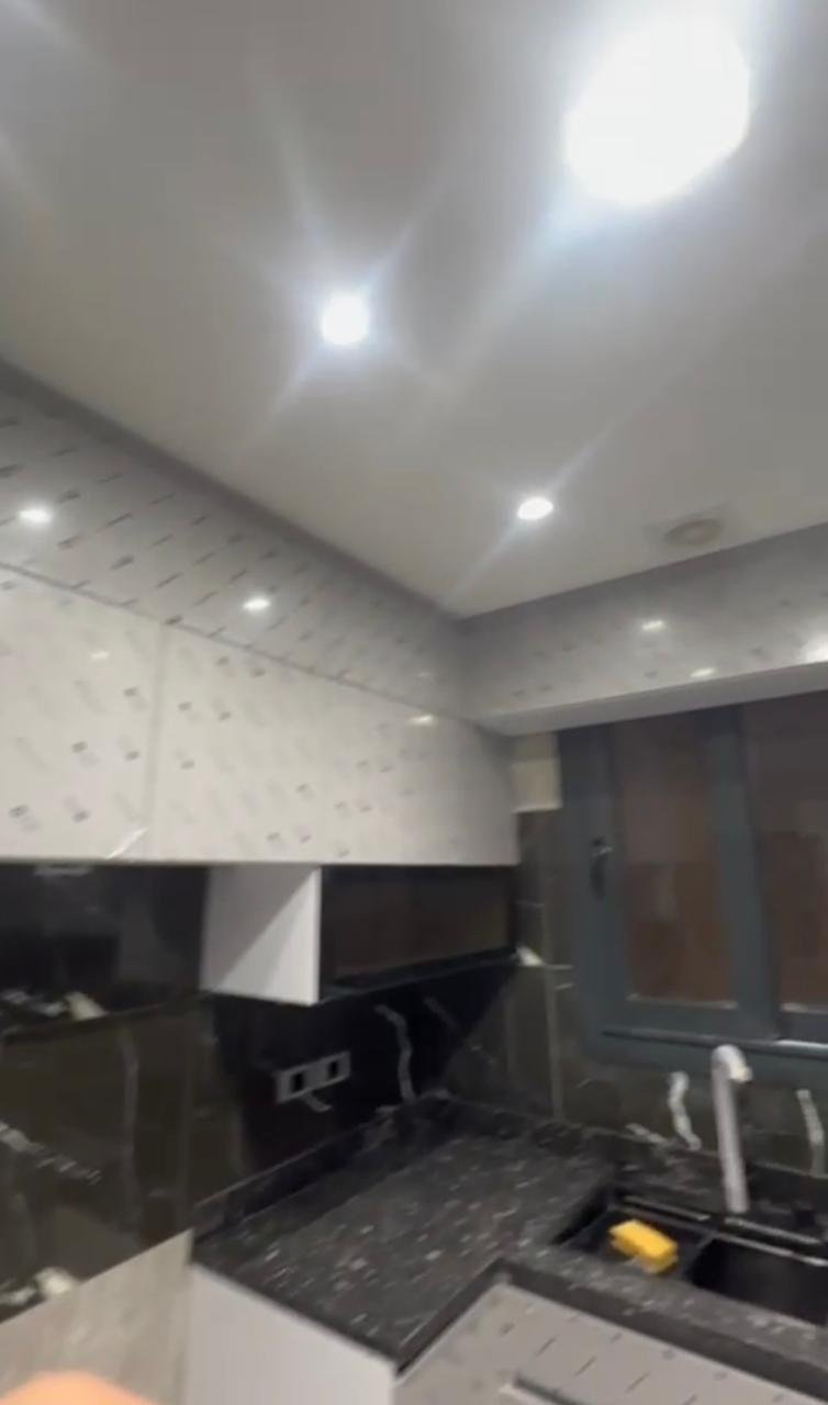 Kitchen corner with black marble and recessed ceiling lights - apartment in El Patio Oro, New Cairo