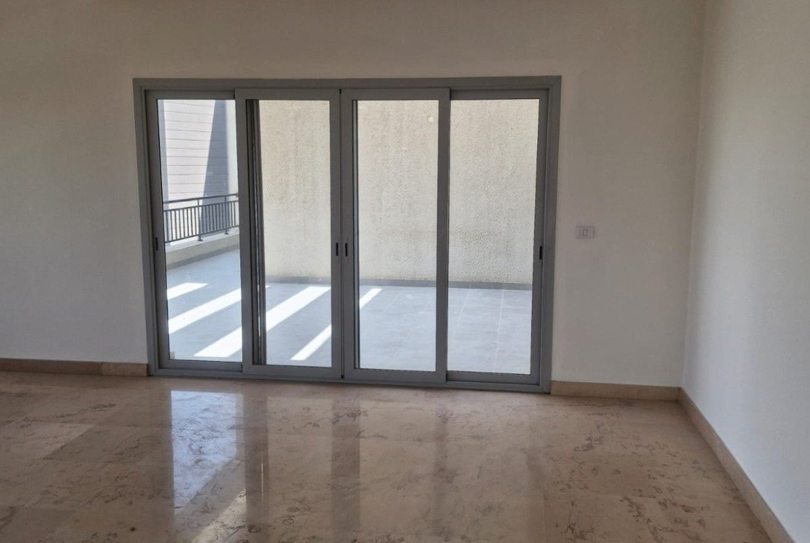 Room with glass doors and a marble floor - penthouse in Cairo Festival City, New Cairo