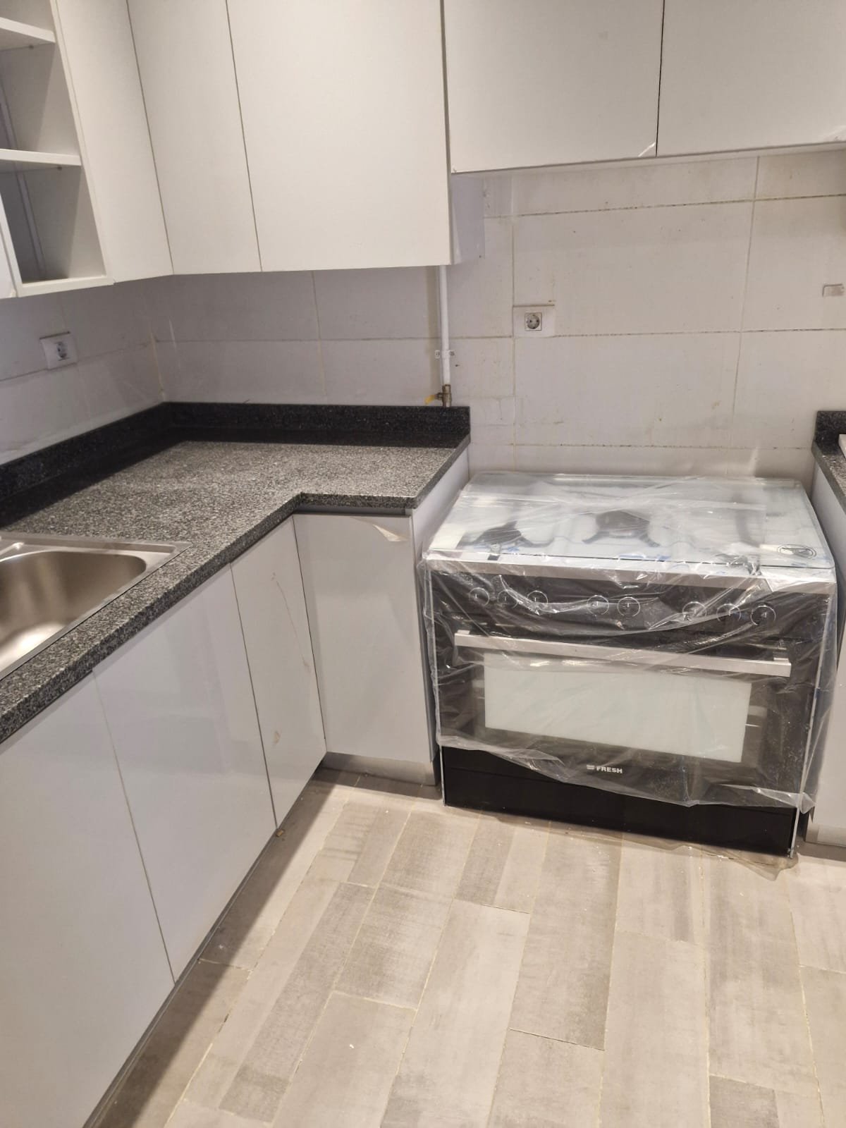 penthouse-for-rent-cfc-new-cairo-378-sqm-332-kitchen-oven Kitchen with a steel cooker and a grey plank-look floor - penthouse in Cairo Festival City, New Cairo