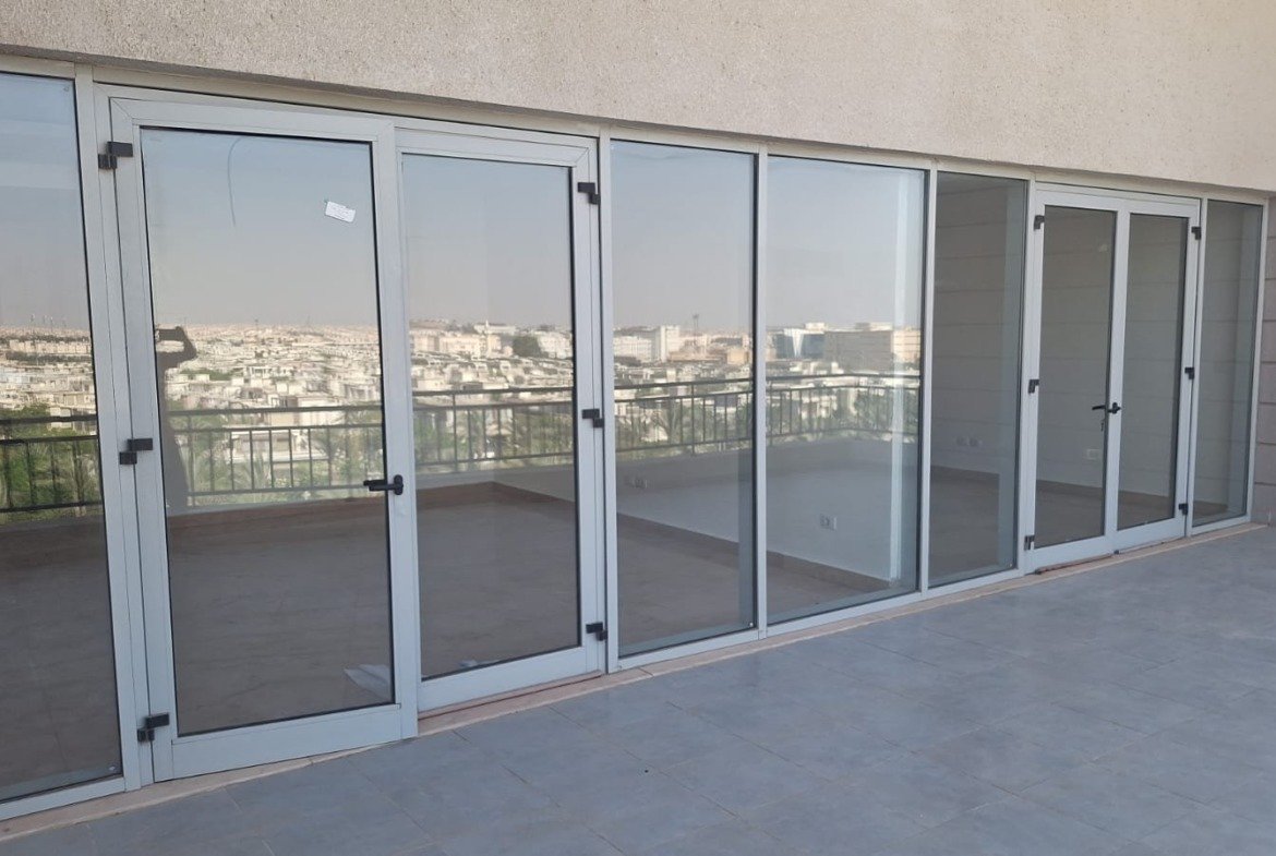 Long sliding glass wall facing the terrace - penthouse in Cairo Festival City, New Cairo