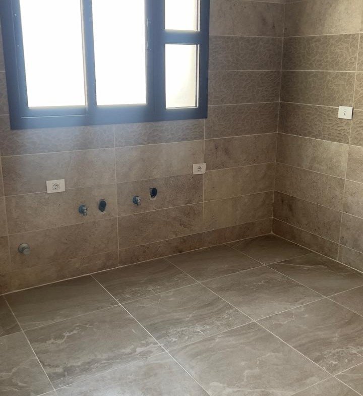 Empty bathroom with window - penthouse in Fifth Square, New Cairo