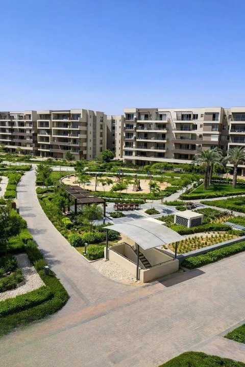 Aerial view of formal gardens between apartment buildings - apartment in Palm Hills, New Cairo
