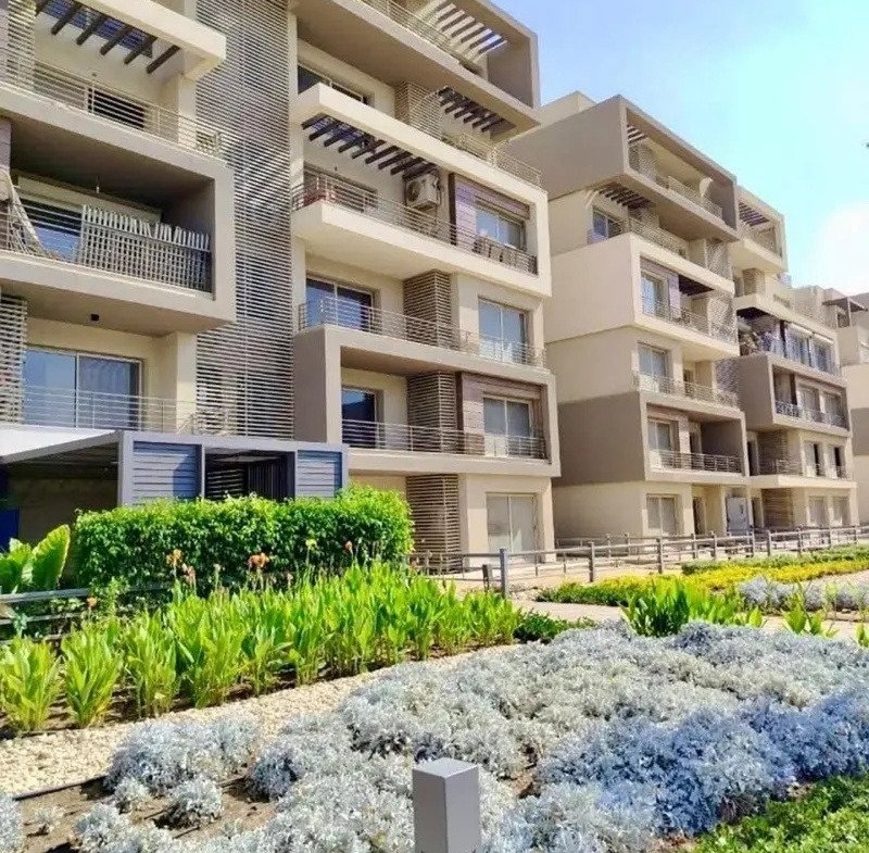 Apartment block with garden beds in the foreground - apartment in Palm Hills, New Cairo