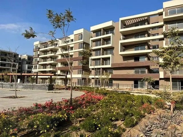 Wide view of apartment blocks with planted garden beds - apartment in Palm Hills, New Cairo
