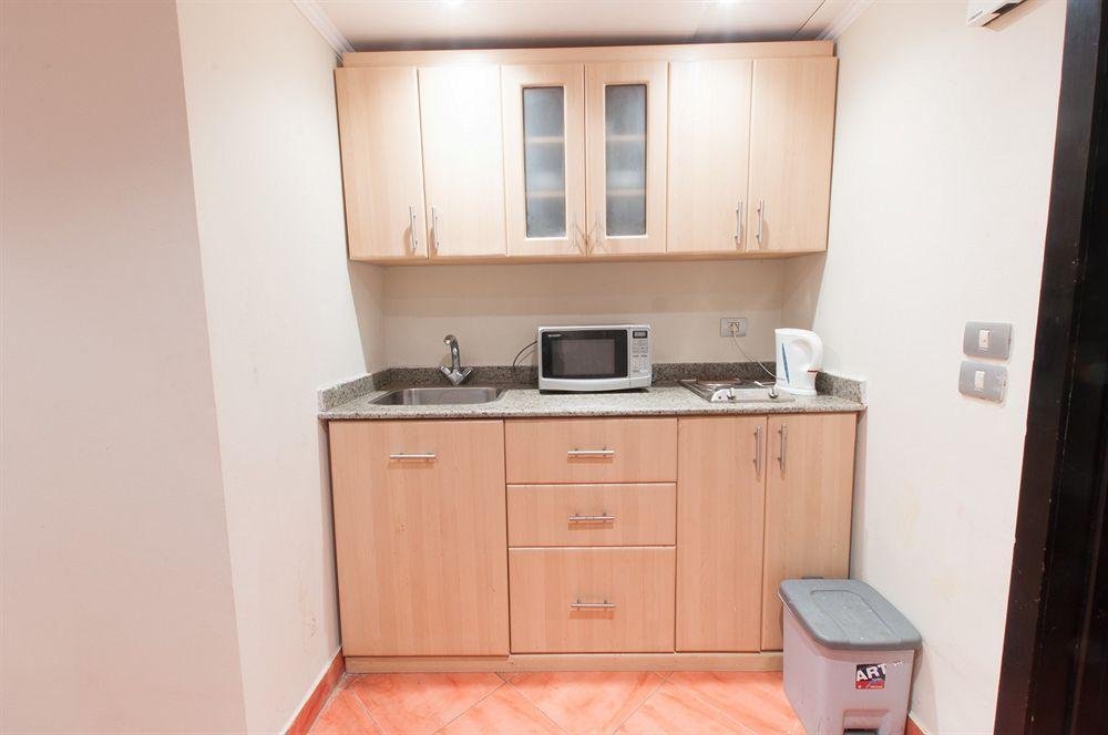 Compact kitchenette with light wood cabinets and microwave - chalet in Porto Marina, North Coast