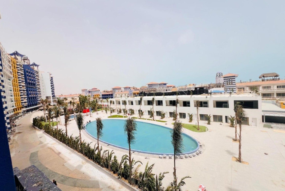 Pool and terraced low-rise buildings seen from above - chalet in Porto Marina, North Coast