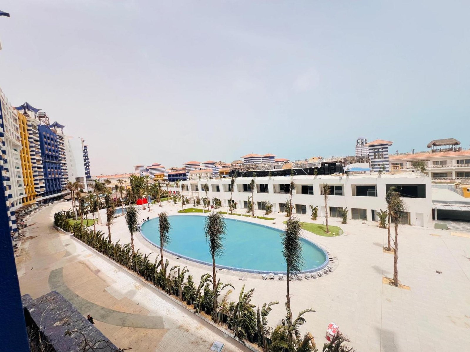 Pool and terraced low-rise buildings seen from above - chalet in Porto Marina, North Coast