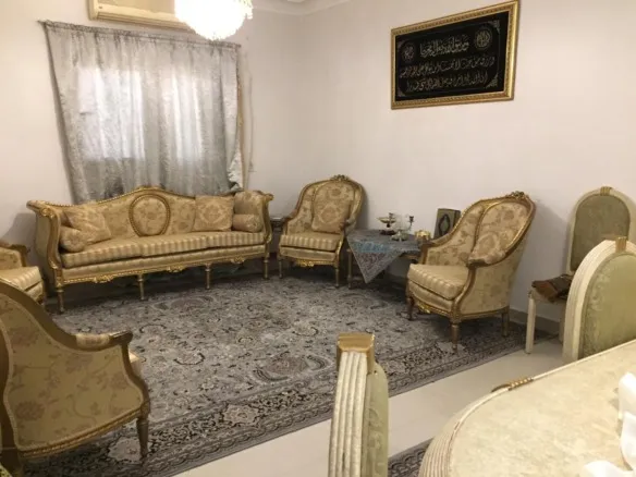 Classic reception with gold-colored seating in Al Banafseg 2