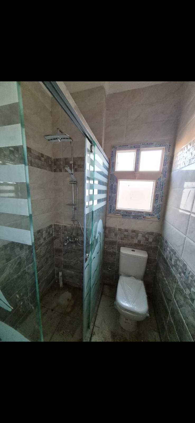 Small bathroom with a toilet and a high window - unit in Al Banafseg 4, New Cairo