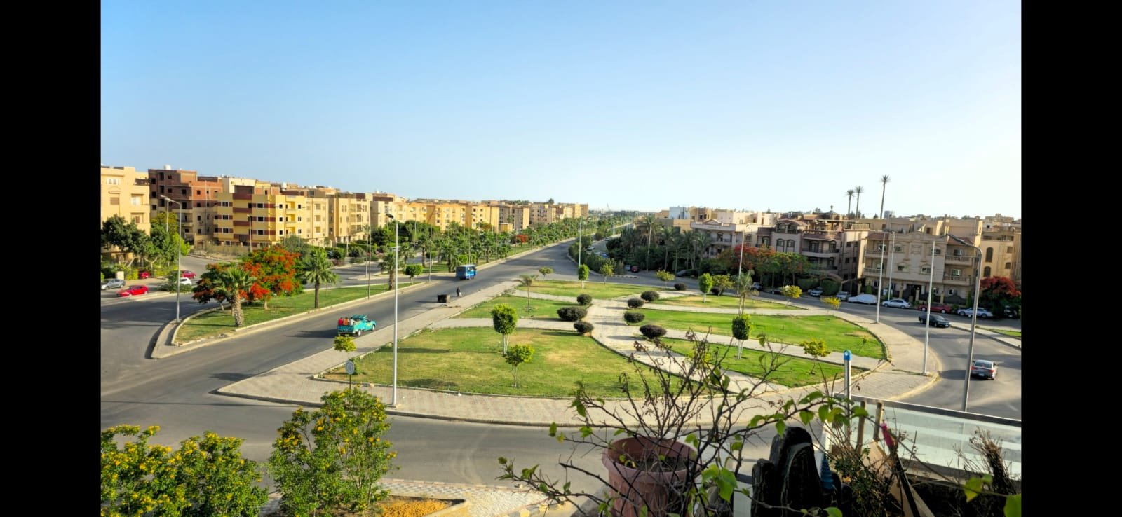 View of a green roundabout and the neighbourhood from the balcony - unit in Al Banafseg 4, New Cairo