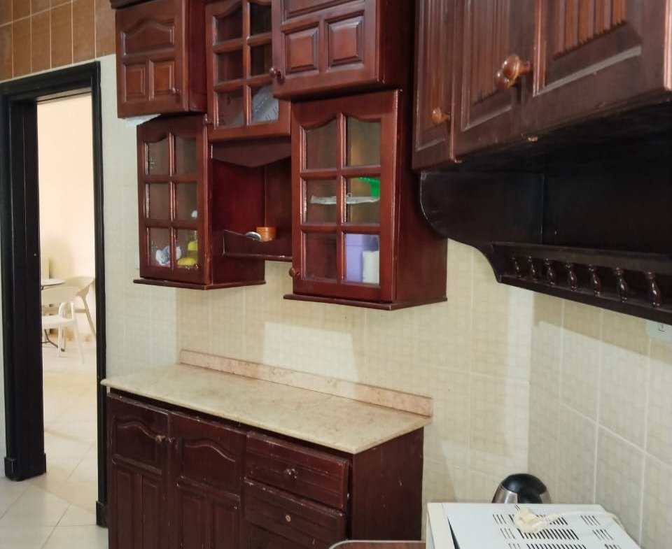 Kitchen with dark wood cabinets - chalet in Rozana, North Coast
