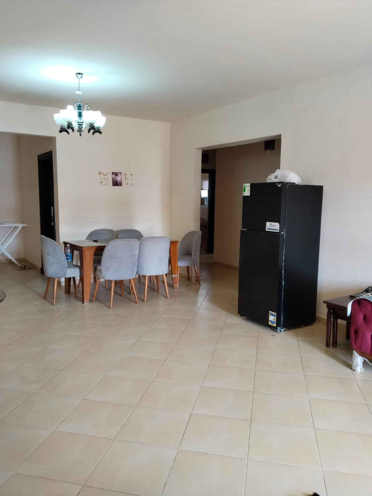 Dining area with chairs and a dark fridge - chalet in Rozana, North Coast