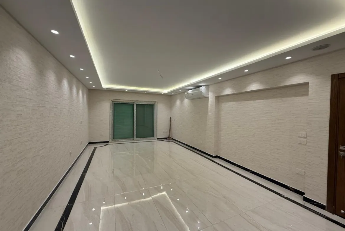 Long reception with a lit ceiling edge and glossy marble floor - apartment in Sakan Compound, New Cairo