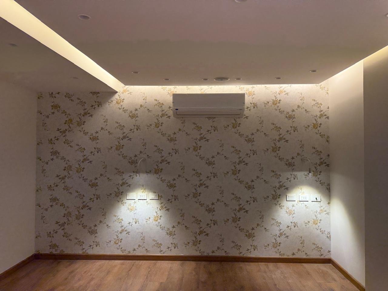 Wall with patterned wallpaper and two wall lights - apartment in Sakan Compound, New Cairo