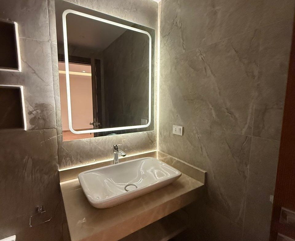 Vanity with a backlit mirror and a countertop basin - apartment in Sakan Compound, New Cairo