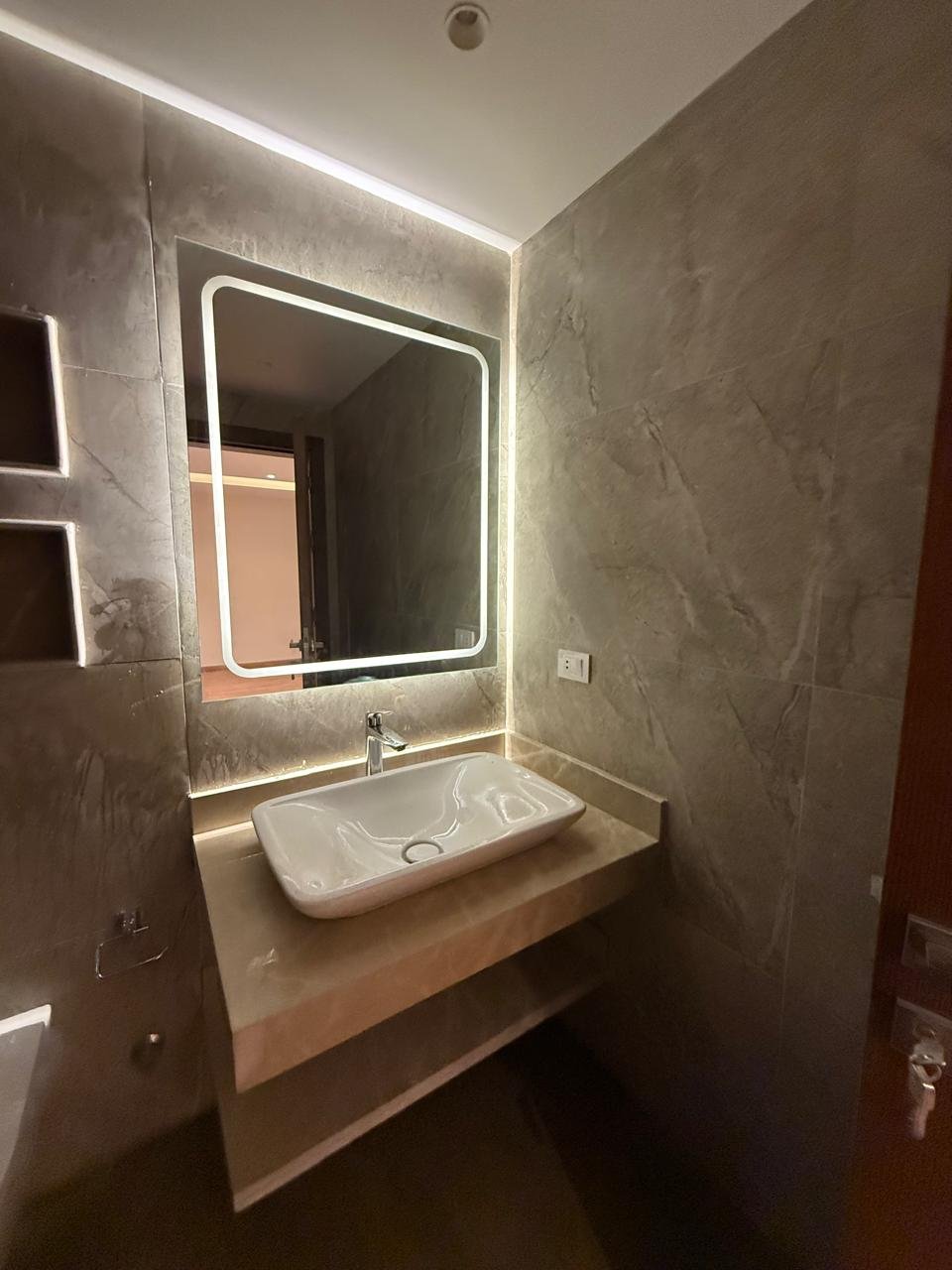 Vanity with a backlit mirror and a countertop basin - apartment in Sakan Compound, New Cairo