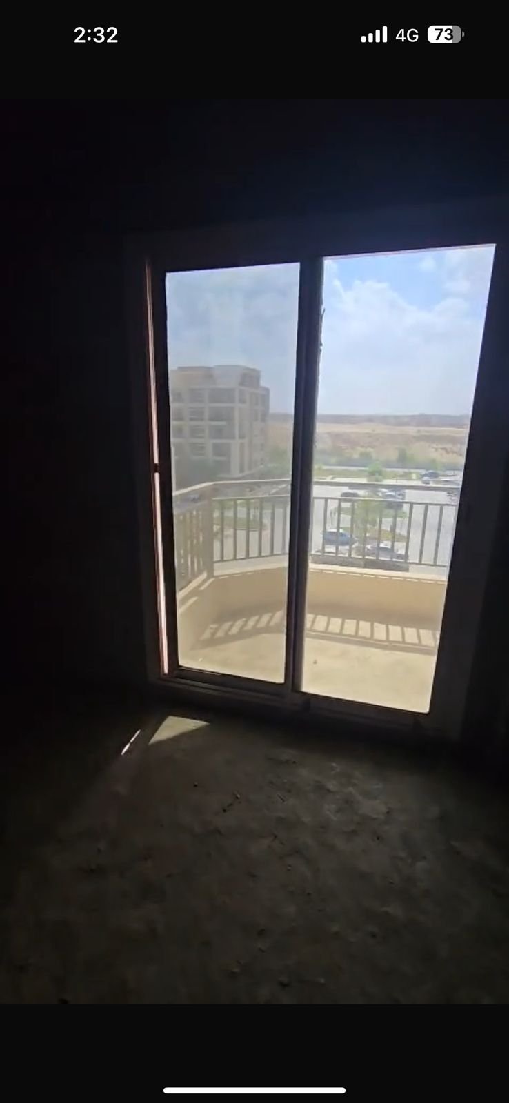 Unfinished room with a wide window overlooking buildings - apartment in Taj City, New Cairo