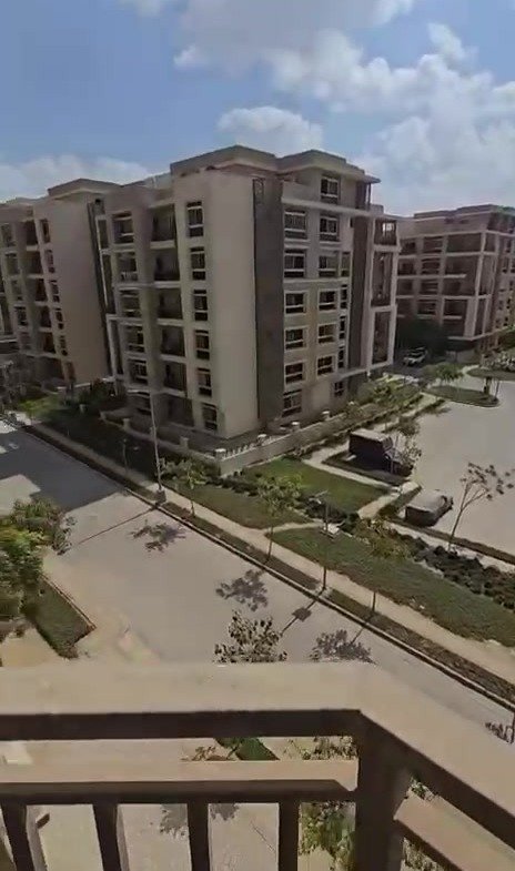 Elevated view over the compound's buildings and gardens - apartment in Taj City, New Cairo