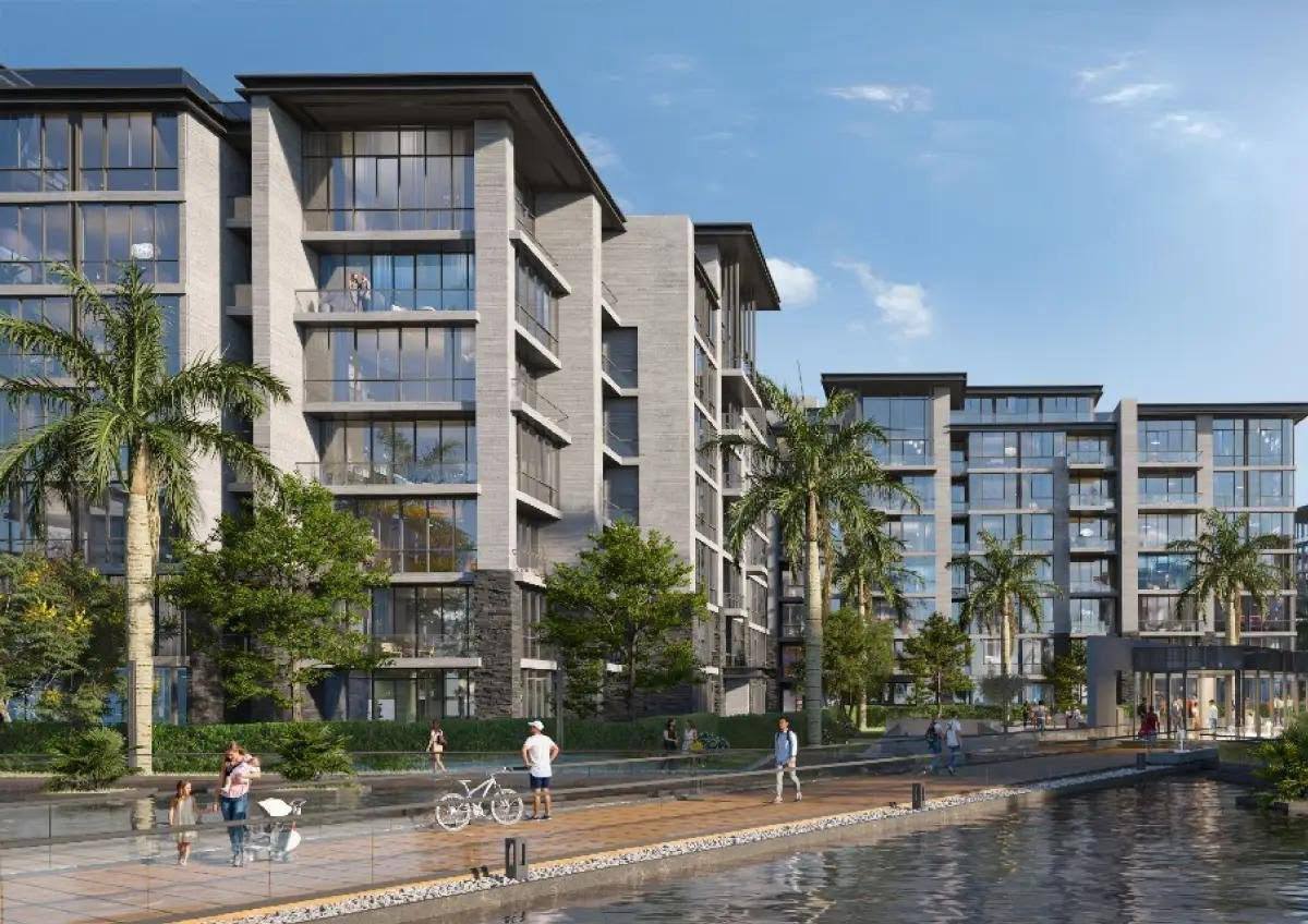 Apartment buildings along a water channel with a promenade - apartment in The View by Waterway, New Cairo