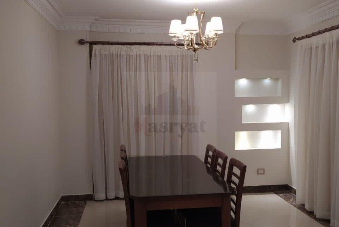 Dining table with curtains and a small chandelier - apartment in 3rd District, New Cairo