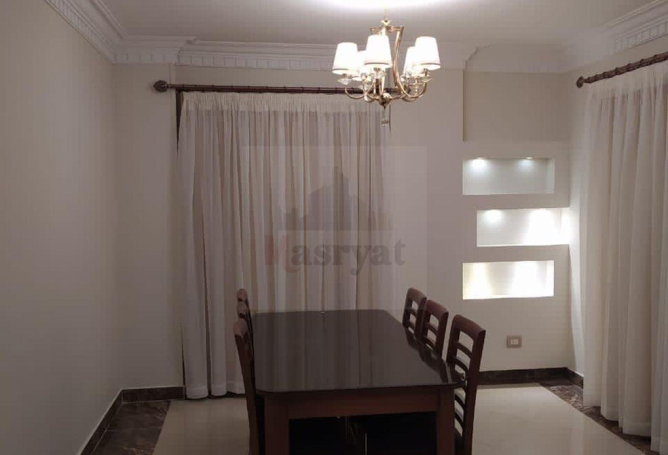 third-district-apt-135-02 Dining table with curtains and a small chandelier - apartment in 3rd District, New Cairo