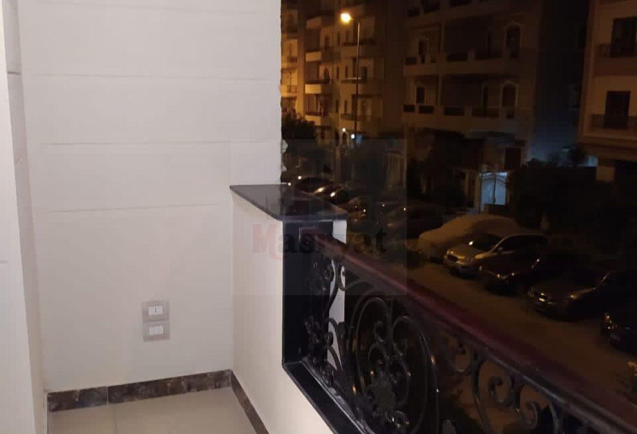 third-district-apt-135-03 Balcony with ornate railing and night view of the street - apartment in 3rd District, New Cairo