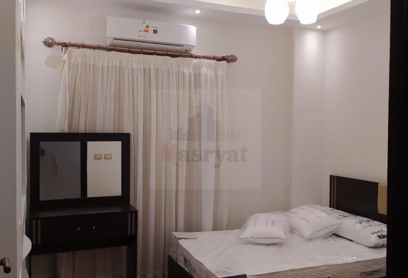 third-district-apt-135-04 Bedroom with a wall air conditioner and sheer curtains - apartment in 3rd District, New Cairo