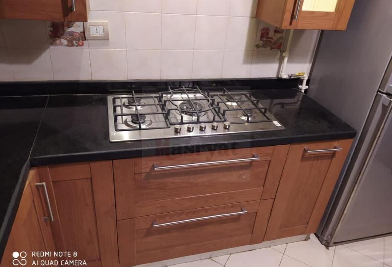 third-district-apt-135-09 Gas hob set into a black kitchen counter - apartment in 3rd District, New Cairo