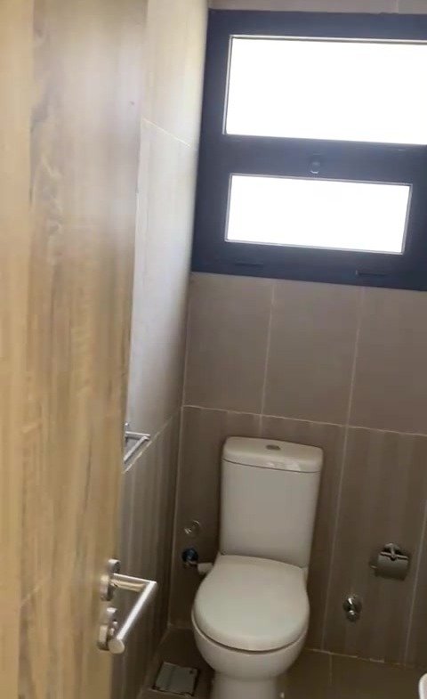 Bathroom with toilet and window - apartment in Fifth Square, New Cairo